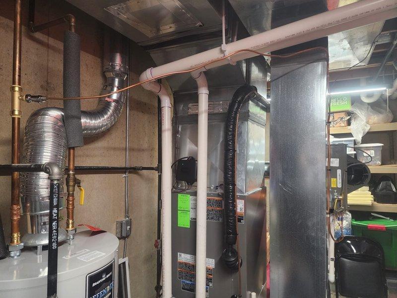 Diagnosed humidifier (HUM) malfunction affecting zones 5-9. Inspected water heater and associated plumbing connections. Examined HVAC system including furnace/air handler, ductwork, and ventilation components for potential relationship to humidity control issues.