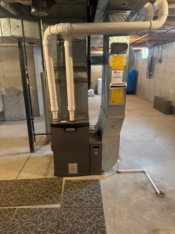 Successfully installed new Lennox furnace and S40 thermostat in unfinished basement area. Installation included proper connection of PVC ventilation pipes with appropriate routing along ceiling joists and installation of condensate drain line. System was fully tested and is operating within manufacturer specifications.