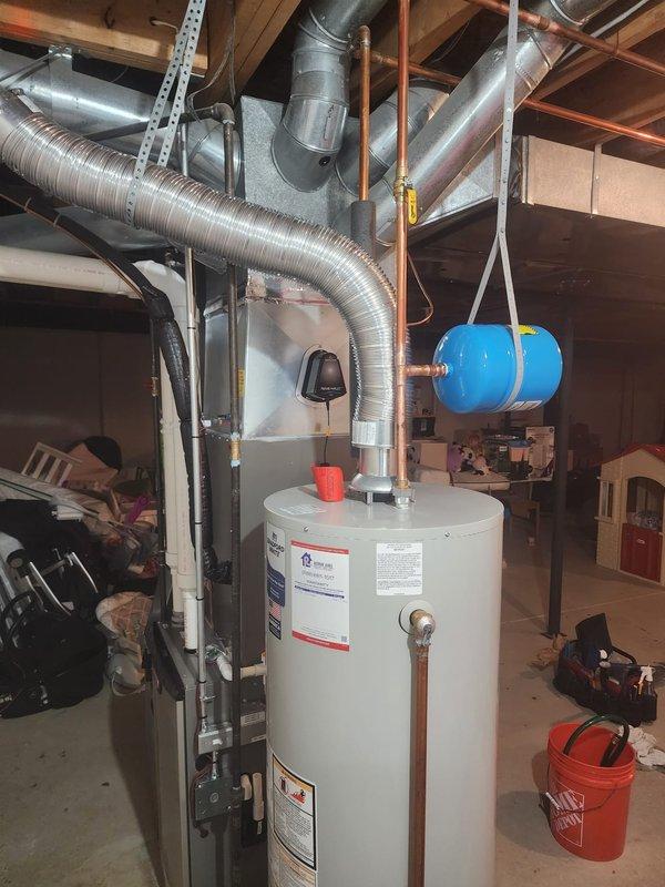 Successfully installed a 50-gallon water heater in basement mechanical room, including proper connections to existing copper plumbing and drain line to floor drain. Installation included mounting of expansion tank and testing of all connections to ensure proper operation and no leaks.