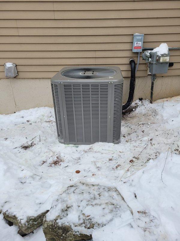 Completed installation of a complete HVAC system featuring a new Lennox furnace and air conditioning unit. The outdoor condenser was properly mounted on a concrete pad with all necessary electrical connections and refrigerant lines installed according to manufacturer specifications, despite winter conditions.