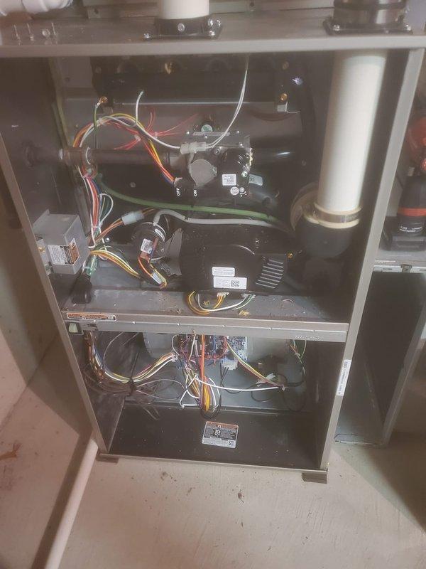 Completed scheduled maintenance on Bryant HVAC system. Inspected interior components including blower assembly, electrical wiring, and circuit boards. Examined PVC venting system and verified proper installation of exhaust and intake connections on furnace unit.