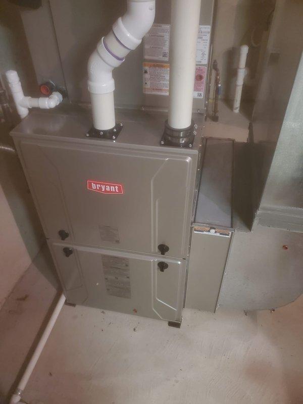 Completed scheduled maintenance on Bryant HVAC system. Inspected interior components including blower assembly, electrical wiring, and circuit boards. Examined PVC venting system and verified proper installation of exhaust and intake connections on furnace unit.