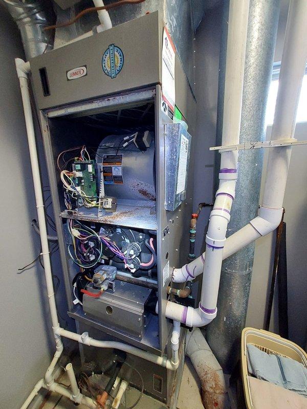 Performed routine bi-system furnace maintenance on aging Lennox units showing signs of dust accumulation and corrosion. Inspected electrical components and circuit boards, noting oxidation on copper pipes and possible moisture issues at the condensate drain connections. Systems operational but exhibiting age-related wear requiring monitoring during future service visits.