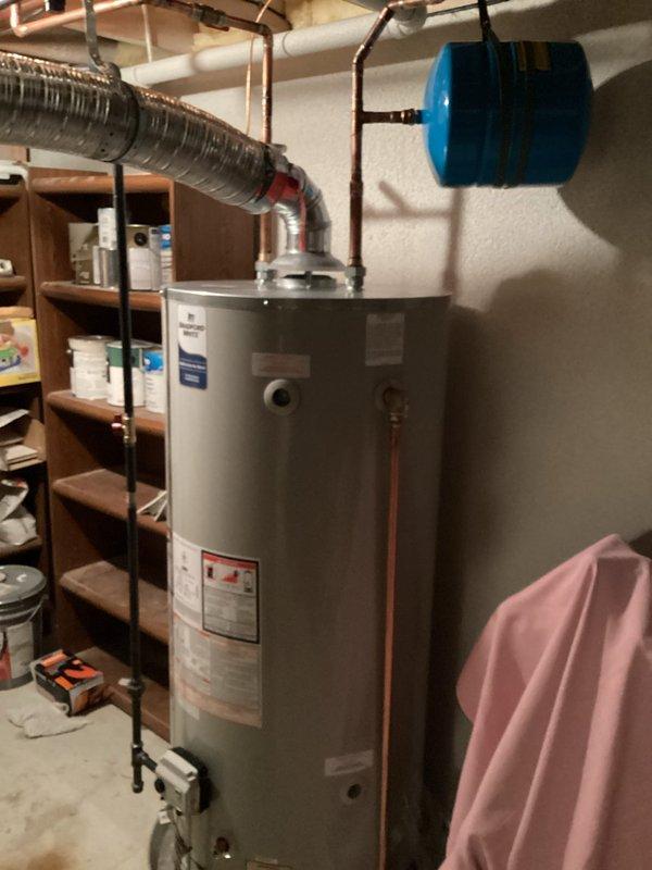 Successfully installed new 75-gallon water heater, replacing and removing two existing tank units. Positioned new water heater closer to wall as specified, and installed expansion tank with proper connections. Complete installation includes all required copper piping and ventilation components for safe, efficient operation.