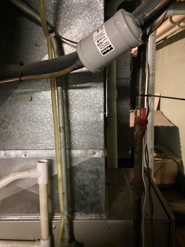 Conducted a replacement estimate for a 16-year-old but functional furnace system located in customer's basement. Visual inspection revealed an aging natural gas furnace with connected ductwork and adjacent water heater. System evaluation included examination of existing ventilation components, insulated ductwork, and associated plumbing connections to determine appropriate replacement options.