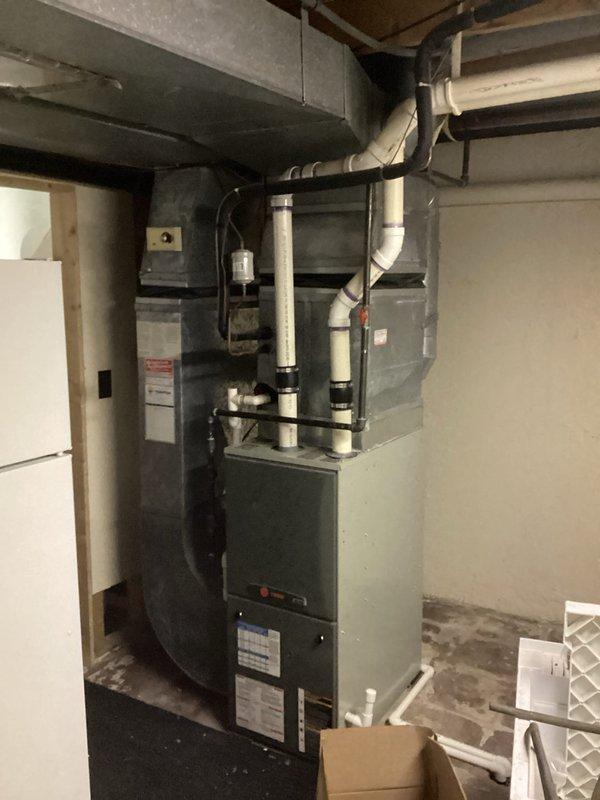 Performed comparative estimate for furnace replacement after customer reported another company diagnosed failed inducer motor and cracked heat exchanger in their 18-year-old unit. Visual inspection confirmed aging system with standard PVC venting configuration and adequate installation space in utility room. Complete system replacement recommended due to critical safety concerns and equipment age.