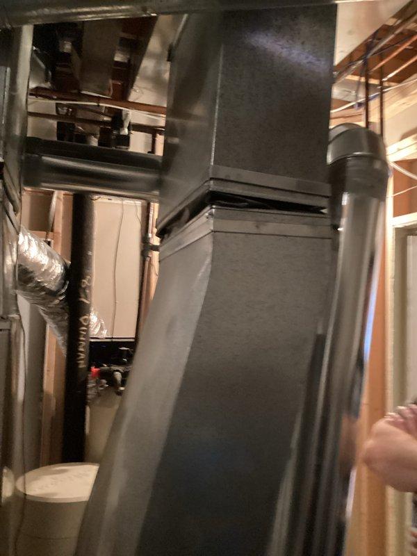 Conducted inspection and provided estimate for furnace replacement. Current unit appears to be an older model installed in basement/utility room with existing ductwork and ventilation system. Documented condition of current installation including connections, platform mounting, and PVC drainage components to determine appropriate replacement specifications.