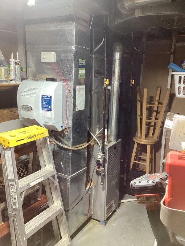 Conducted comprehensive assessment of original 1988 HVAC system requiring replacement. Inspection revealed outdated furnace with attached humidifier in utility room and outdoor condenser unit showing significant wear and exposure to elements. Recommended complete system replacement with modern energy-efficient equipment, discussed financing options with homeowner.