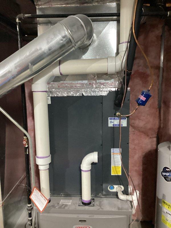 Completed replacement estimate for quote #03727-02 FRN. Documented existing water heater installation with associated plumbing connections and a furnace system with proper ductwork, PVC intake/exhaust venting, and electrical components. System is installed in a utility area with fiberglass insulation and appears to be in normal working condition.