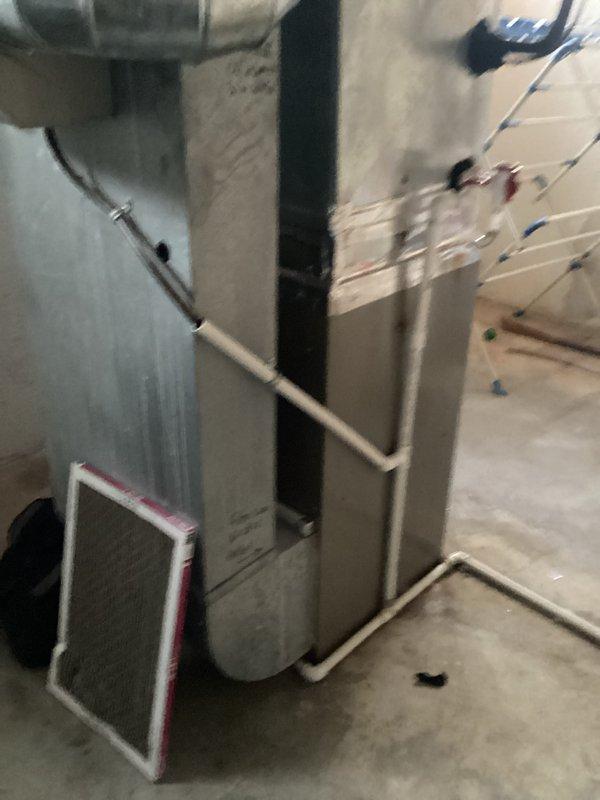 Conducted comprehensive assessment of aging HVAC system requiring replacement rather than repair due to cost inefficiency. Documented existing installation including furnace unit with attached ductwork, control components, and PVC ventilation/drainage system. Prepared estimate for complete system replacement as recommended alternative to expensive repairs on deteriorating equipment.