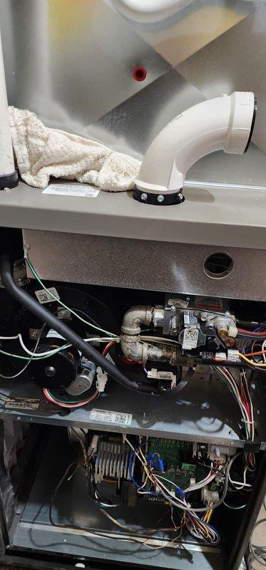 Performed annual maintenance on 1-year-old furnace under Worry Free Service Agreement. Inspected interior components including gas valve assembly, control board, electrical connections, and PVC venting system. All systems functioning properly with no issues identified; unit is operating at optimal efficiency with clean components and proper drainage confirmed.