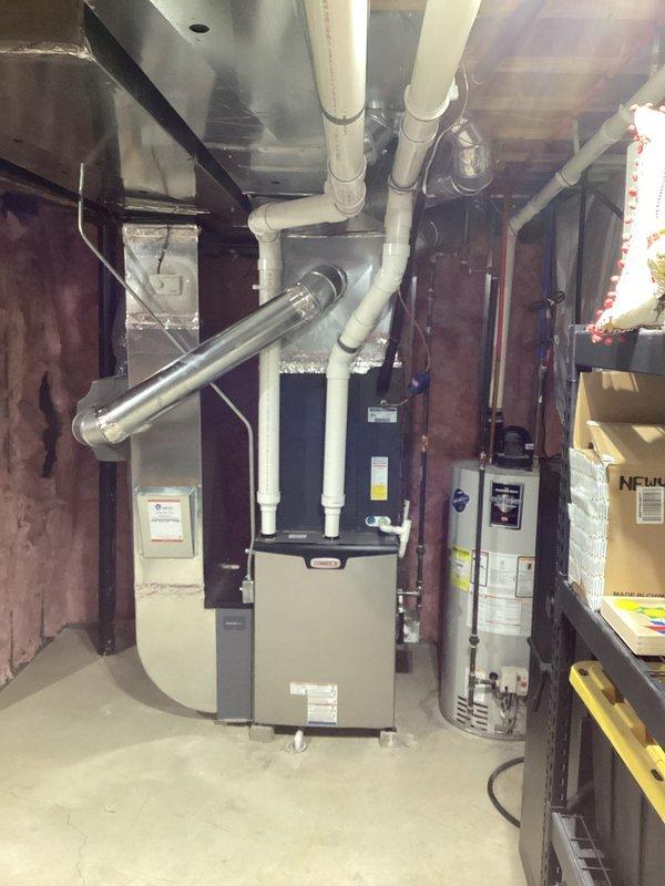 Successfully installed new Lennox furnace in basement utility area, including proper connection of white PVC vent pipes to the existing exhaust system. Completed all necessary ductwork connections and ensured proper integration with the existing water heating system.