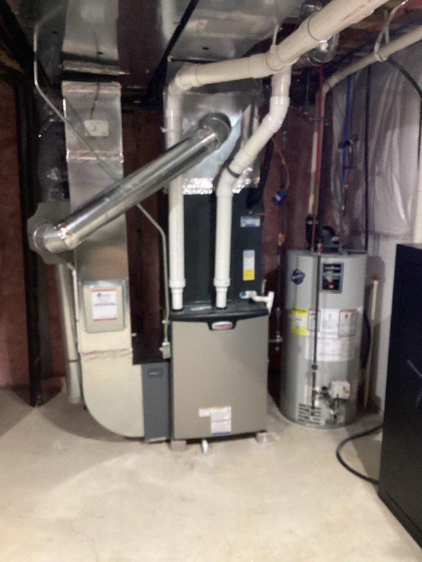 Successfully installed new Lennox furnace in basement utility area, including proper connection of white PVC vent pipes to the existing exhaust system. Completed all necessary ductwork connections and ensured proper integration with the existing water heating system.