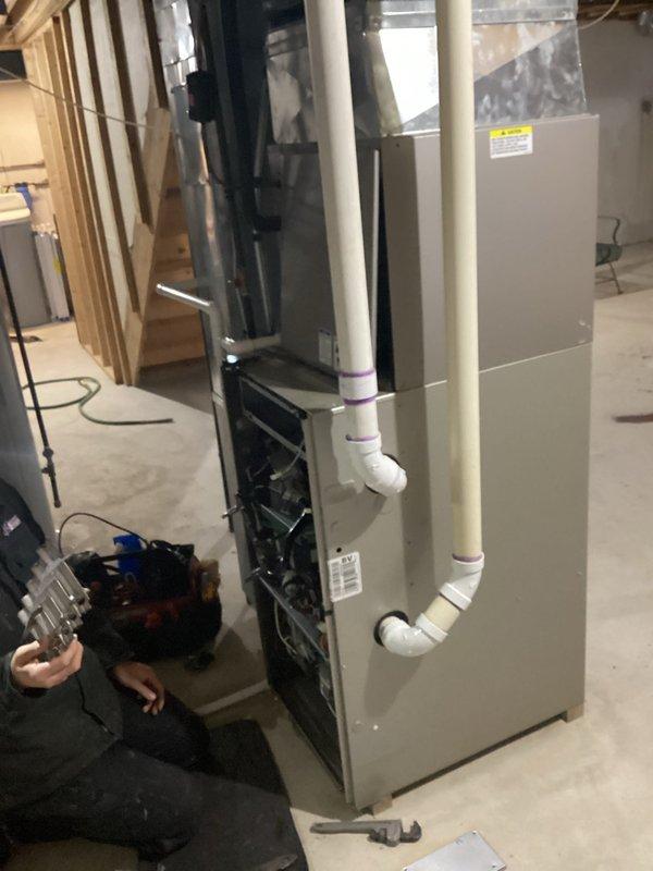 Completed estimate for replacement of existing HVAC system. Evaluated current furnace installation in unfinished basement with PVC venting and drainage components. Assessed exterior Bryant air conditioning unit positioned against house siding on concrete pad, currently surrounded by snow accumulation.