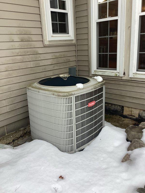 Completed estimate for replacement of existing HVAC system. Evaluated current furnace installation in unfinished basement with PVC venting and drainage components. Assessed exterior Bryant air conditioning unit positioned against house siding on concrete pad, currently surrounded by snow accumulation.