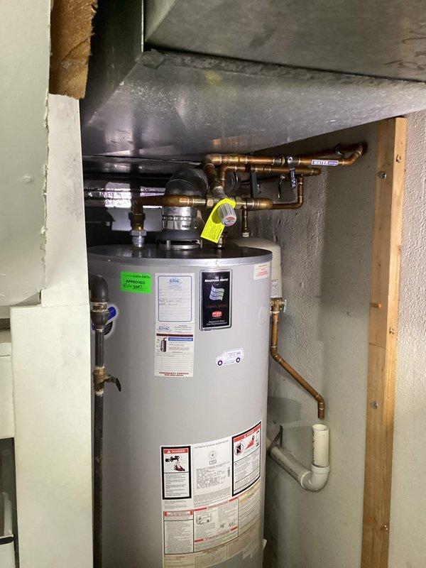 Successfully completed water heater replacement in residential basement setting. Installed new unit with proper copper and PVC connections, ensuring all plumbing was correctly routed and secured. System was tested and confirmed operational with appropriate drainage setup.