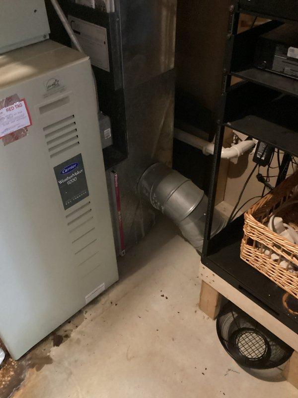 Conducted on-site evaluation of existing Carrier HVAC system in basement utility area. Assessed current equipment configuration including furnace/air handler with associated ductwork and ventilation components. Documented system condition and space constraints for potential replacement options. Prepared estimate for complete system replacement based on inspection findings.