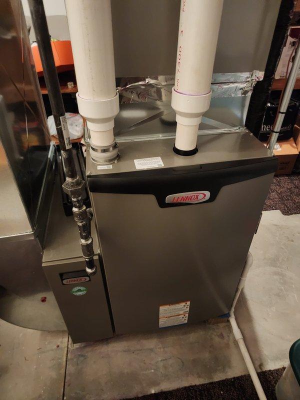 Performed scheduled maintenance on two Lennox furnace systems located in basement utility area. Both units were inspected, cleaned, and tested for proper operation. PVC exhaust/intake pipes were examined for secure connections and proper venting.