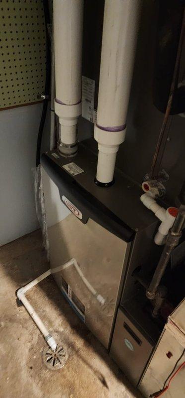 Performed comprehensive heating maintenance service on residential HVAC system under Worry Free Service Agreement. Inspected furnace unit, verified proper operation of intake and exhaust PVC venting, and checked all plumbing connections including copper pipes and valves. System appears to be an ALLSTYLE brand unit installed in basement utility area.