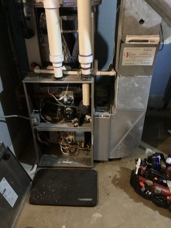 Conducted inspection of existing furnace system with exposed internal components including wiring, motor, and control boards. Performed assessment of current ductwork configuration, including Y-junction connections and metal duct seams. Prepared estimate for complete HVAC system replacement with appropriate PVC venting and condensate drainage solutions.