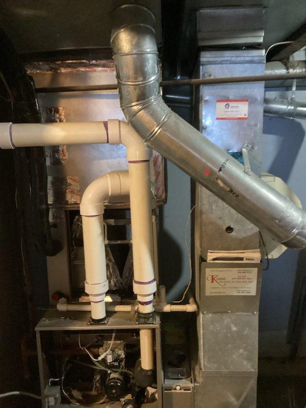 Conducted inspection of existing furnace system with exposed internal components including wiring, motor, and control boards. Performed assessment of current ductwork configuration, including Y-junction connections and metal duct seams. Prepared estimate for complete HVAC system replacement with appropriate PVC venting and condensate drainage solutions.