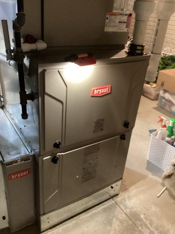 Responded to service call for leaking humidifier. Inspected Bryant HVAC system located in utility room, finding water leakage from the humidifier unit. Replaced humidifier filter and resolved leak by properly securing connections. Performed additional furnace maintenance including inspection of internal components, control board, and wiring connections to ensure proper system operation.