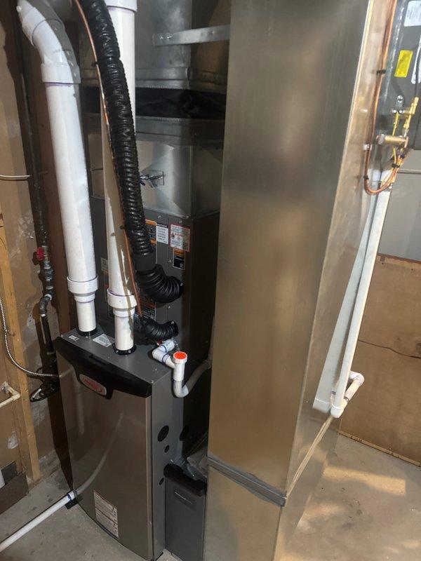 Successfully installed a complete HVAC system including a Lennox furnace with properly connected PVC intake/exhaust pipes, an air conditioning unit, S40 thermostat, and humidifier mounted to the ductwork. All components were professionally installed with appropriate connections to existing ductwork, electrical systems, and copper lines in the utility area, with the system fully tested and operational upon completion.