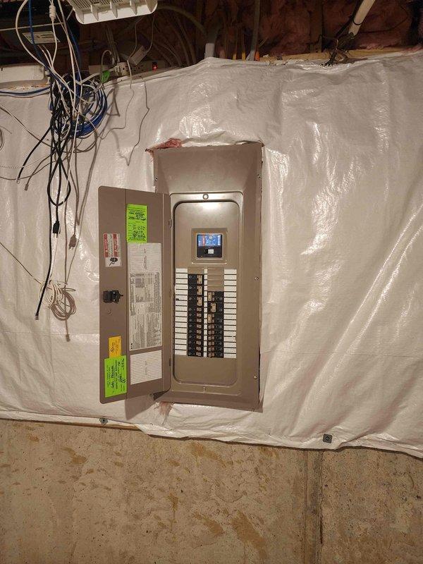 Completed site assessment for EV charger installation, evaluating electrical service panel capacity and configuration. Inspected main breaker panel with digital display meter, documented existing circuit layout, and determined available space for new dedicated circuit. Assessment confirmed suitable infrastructure for 240V Level 2 charging station installation with minor modifications to existing electrical system required.