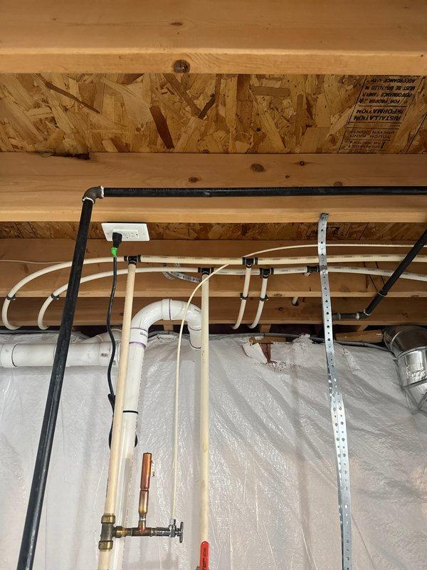 Successfully installed a 50-gallon Bradford White water heater with all necessary connections and safety components. Installation included proper fitting of copper supply lines, shutoff valves, and a blue expansion tank mounted on metal brackets. All connections were tested and verified to be leak-free with system functioning as designed.