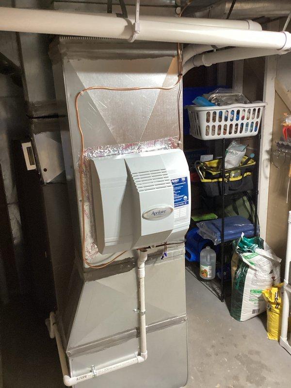 Successfully completed installation of a complete Lennox HVAC system including furnace, air conditioner, S40 thermostat, and Air Scrubber in customer's utility area. System installation included proper connection of all components with PVC venting and addition of an Aprilaire humidifier to enhance indoor air quality and comfort.