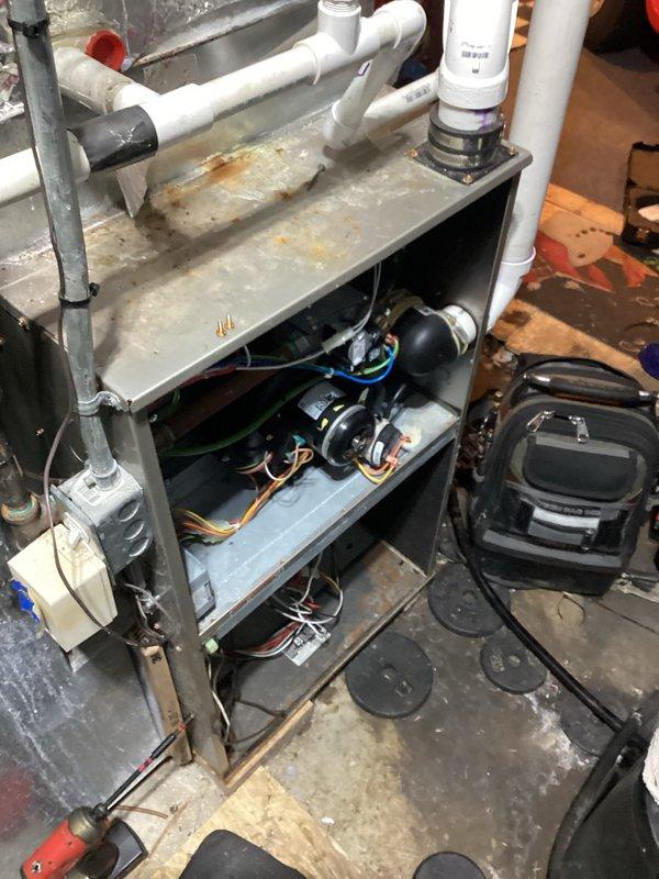 Performed comprehensive assessment of aging HVAC system showing significant wear, including rust development on metal components and evidence of water damage on surrounding floor. Inspection revealed deteriorated electrical components within the mechanical unit, compromised PVC piping connections, and suboptimal ductwork insulation. Recommended complete system replacement to address reliability concerns and improve energy efficiency.