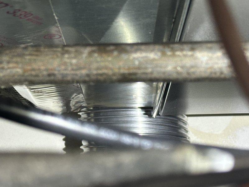 Responded to callback for whistling noise from newly installed 90,000 BTU furnace. Inspection revealed improper sealing at connection points, confirmed by evidence of corrosion on existing pipe fitting adjacent to newer coil components. Resealed all furnace connections and verified proper operation of complete system (4-ton AC, S40 thermostat, and humidifier) with no further noise issues.