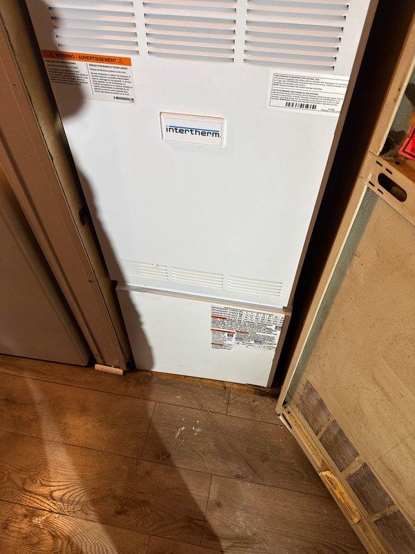 Successfully installed a complete HVAC system including a Revolv furnace, Lennox air conditioner, and T6 thermostat in the customer's utility area. The Intertherm unit was properly mounted within the wooden framed enclosure with all manufacturer labels intact and visible, and the system was tested to ensure optimal functionality.
