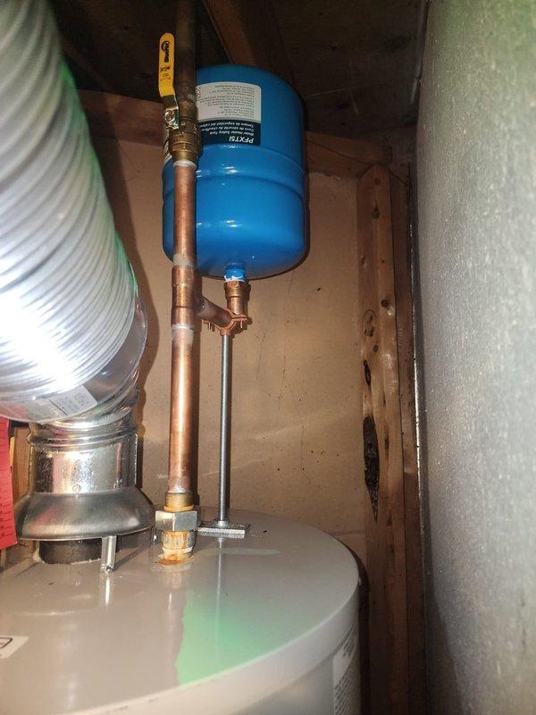Conducted follow-up inspection on expansion tank installation. Verified proper mounting of the blue expansion tank connected to copper piping system with brass valve. Confirmed no leaks at connections and adequate support structure for the tank as per manufacturer specifications.