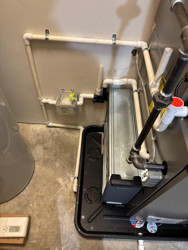 Completed installation of a complete HVAC system including a new Lennox furnace, air conditioner, and Ecobee6 smart thermostat. System installation included proper condensate drainage with PVC piping, electrical connections with junction box and toggle switch, and all necessary mechanical components mounted on appropriate drain pan with secure wall brackets.