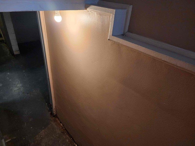 Conducted site assessment of 8 buildings to evaluate 16 emergency light fixtures. Accessed all locations using master key from lockbox (code 1472) at building 25943. Documented current conditions with photos, focusing on stairwells and interior corners where emergency lighting is installed. Noted existing fixtures' placement and illumination patterns in dimly lit areas.