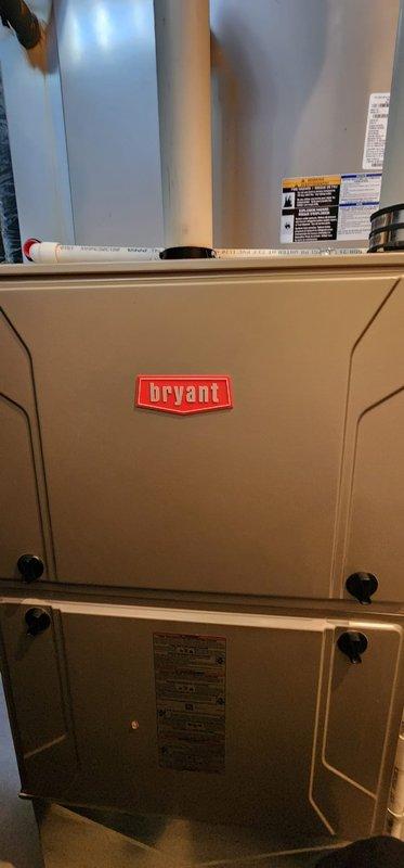 Performed scheduled heating tune-up on 14-year-old Bryant furnace located in basement. Inspected internal components including blower assembly, electrical connections, and control boards; noted some dust accumulation on components but system is functioning properly. Completed all standard maintenance procedures per Worry Free Service Agreement requirements.