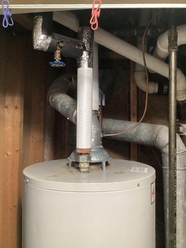 Conducted inspection of 15-year-old water heater showing performance decline. Unit installed in utility closet with proper venting and connections, but exhibiting signs of age-related deterioration. Recommended replacement due to efficiency concerns and estimated remaining service life.