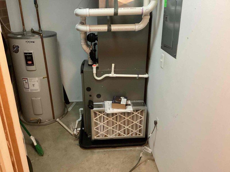 Successfully installed complete HVAC system including new Lennox furnace, air conditioner, and Ecobee6 smart thermostat. System installation included proper connection of condensate drain lines, ductwork integration, and verification of all electrical connections. Final inspection confirmed proper operation of all components with filter properly installed.