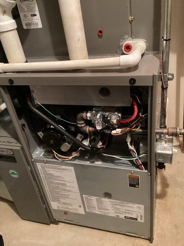 Performed routine maintenance on Lennox furnace system. Inspected all internal components including gas valve assembly, wiring harnesses, and ventilation piping for proper function and safety compliance. Verified proper installation of PVC drainage/ventilation system with all connections secure and operational.