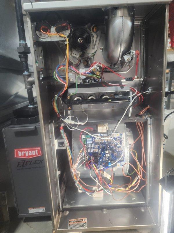 Responded to service call for a Bryant EI-Plus furnace with water leakage and no heat production. Performed diagnostic inspection of internal components including circuit board, blower motor assembly, and pressure switches. Resolved condensate drainage issue from the PVC piping system and restored proper heating functionality.