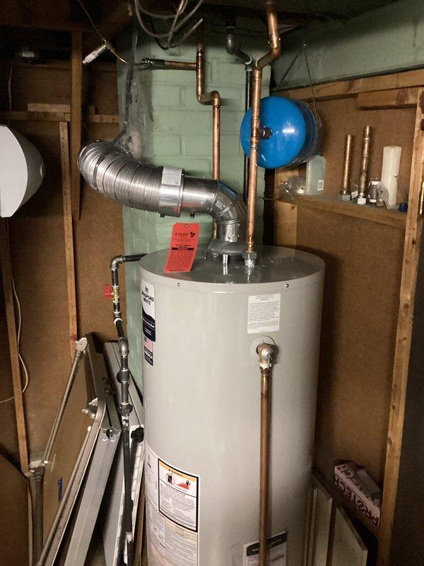 Successfully installed a new 50-gallon water heater in the utility area, including proper connection of copper supply lines and installation of an expansion tank. Completed all necessary venting with flexible metal duct and verified system operation before finalizing installation with appropriate inspection tagging.