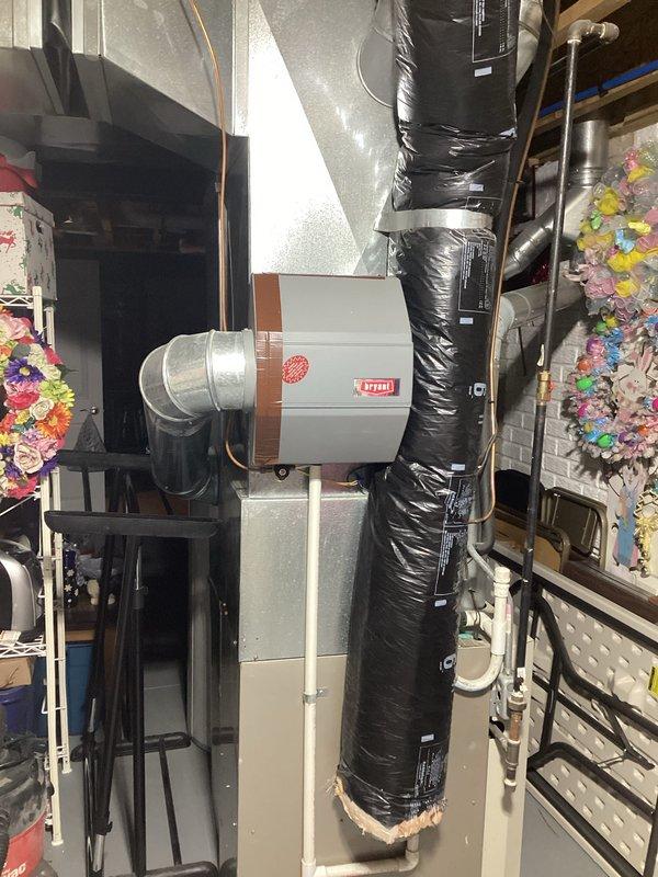 Conducted inspection of 2005 HVAC system located in basement for potential replacement. System includes furnace/air handler with extensive ductwork, insulated ducts, and metal connections. Documented current installation configuration and space constraints to prepare comprehensive replacement estimate for both air conditioning and furnace components.