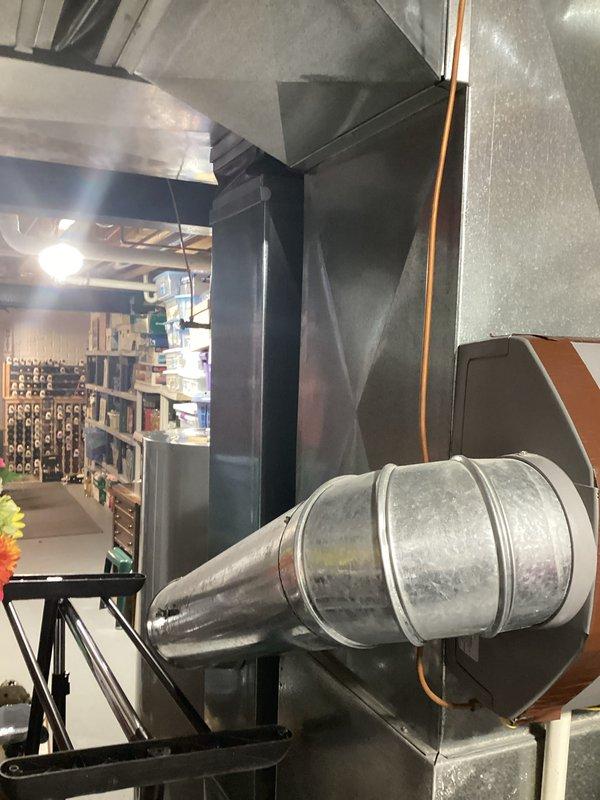 Conducted inspection of 2005 HVAC system located in basement for potential replacement. System includes furnace/air handler with extensive ductwork, insulated ducts, and metal connections. Documented current installation configuration and space constraints to prepare comprehensive replacement estimate for both air conditioning and furnace components.