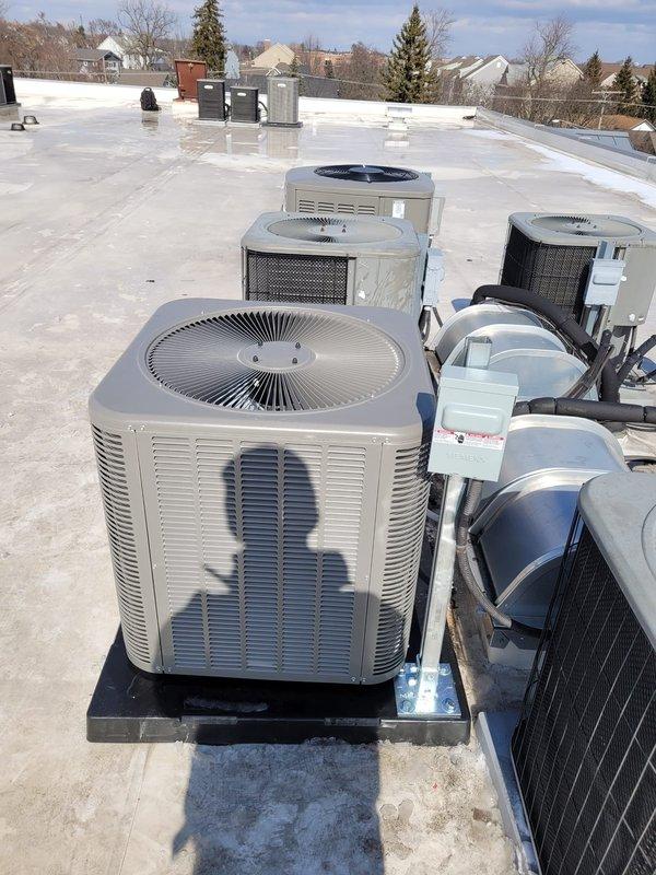 Successfully installed complete Lennox HVAC system including furnace and multiple rooftop air conditioning condensing units. All units were properly mounted on elevated black platform bases with appropriate refrigerant lines and electrical connections completed. Job was finalized with full documentation and verification of system operation.