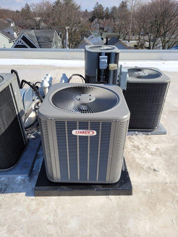 Successfully installed complete Lennox HVAC system including furnace and multiple rooftop air conditioning condensing units. All units were properly mounted on elevated black platform bases with appropriate refrigerant lines and electrical connections completed. Job was finalized with full documentation and verification of system operation.