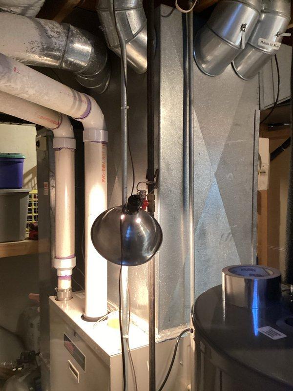 Completed inspection of 25-year-old non-functional furnace system in residential mechanical room. Documented existing equipment condition including air handler, metal ductwork components, flexible duct connections, and associated PVC venting. System has exceeded expected service life with notable wear on housing components, requiring full replacement to restore heating functionality.