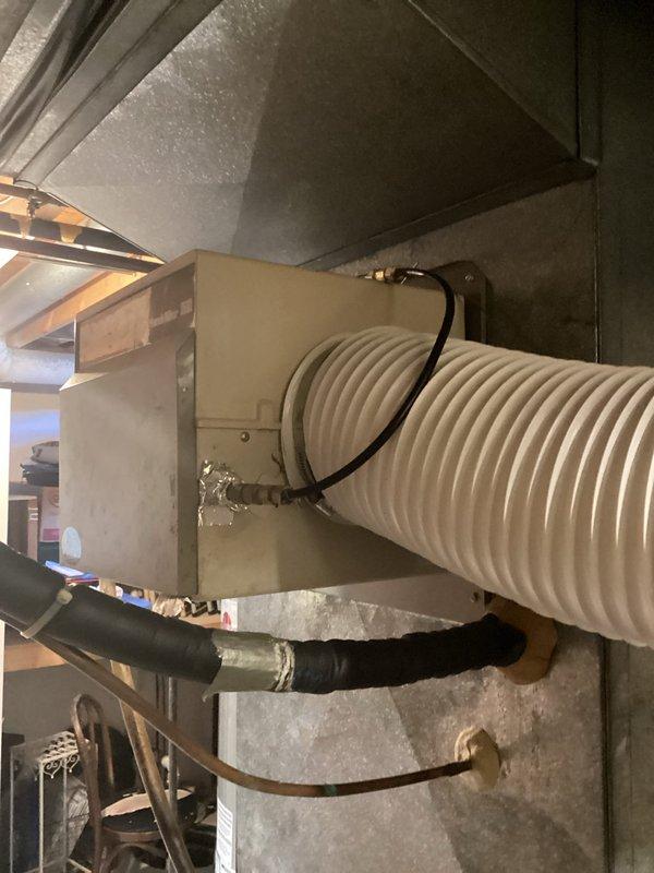 Completed inspection of 25-year-old non-functional furnace system in residential mechanical room. Documented existing equipment condition including air handler, metal ductwork components, flexible duct connections, and associated PVC venting. System has exceeded expected service life with notable wear on housing components, requiring full replacement to restore heating functionality.