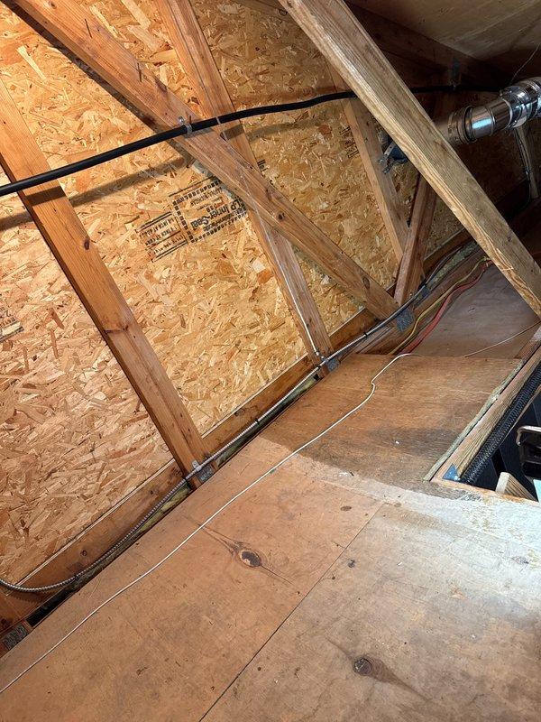 Installed 60,000 BTU Sterling unit heater in garage area, properly suspended from ceiling using metal mounting brackets. Completed all necessary electrical connections through attic/crawlspace, routing wiring through existing structural framework and securing to wooden joists according to code. Unit was tested and confirmed operational with proper airflow distribution.