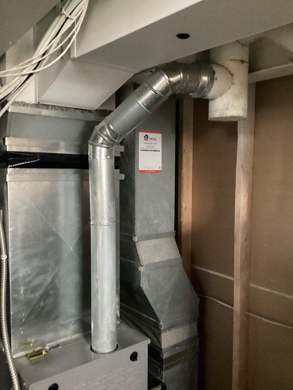 Completed HVAC replacement estimate for residential system located in utility/basement area. Existing installation includes galvanized metal ductwork with 90-degree bends, rectangular supply ducts, and a furnace unit with proper exhaust venting. Assessment included evaluation of current system configuration, ductwork condition, and installation requirements within partially finished space with exposed framing.